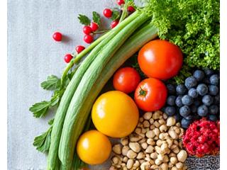 A vibrant green smoothie and fresh fruits, representing functional nutrition.